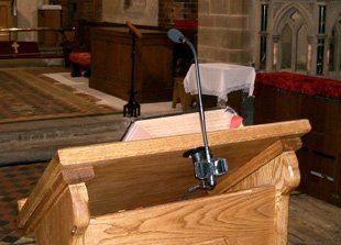 Thinking about installing a new sound system? Call the experts on 01782 626 295 A podium with a microphone attached.