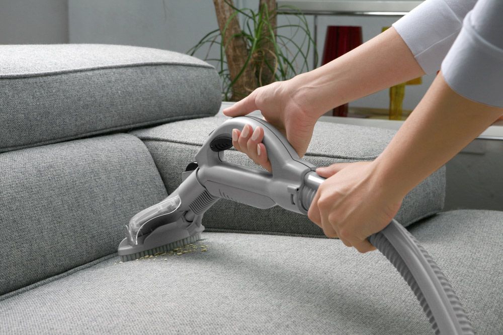A Person Is Cleaning A Couch With A Vacuum Cleaner - Carpet 2 Couch in Condon, QLD