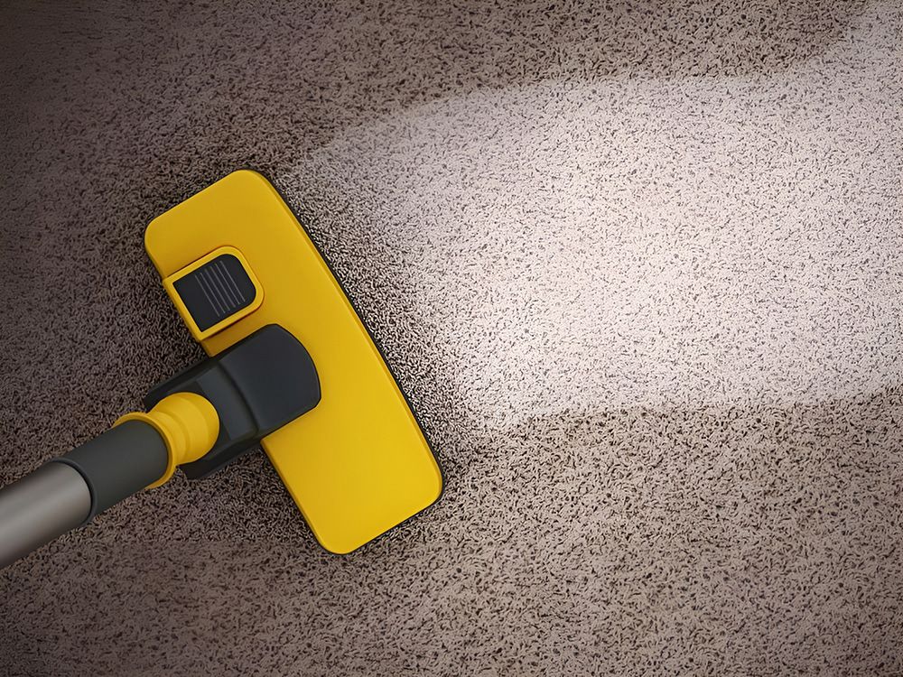 Yellow Vacuum Head Cleaning a Brown Carpet