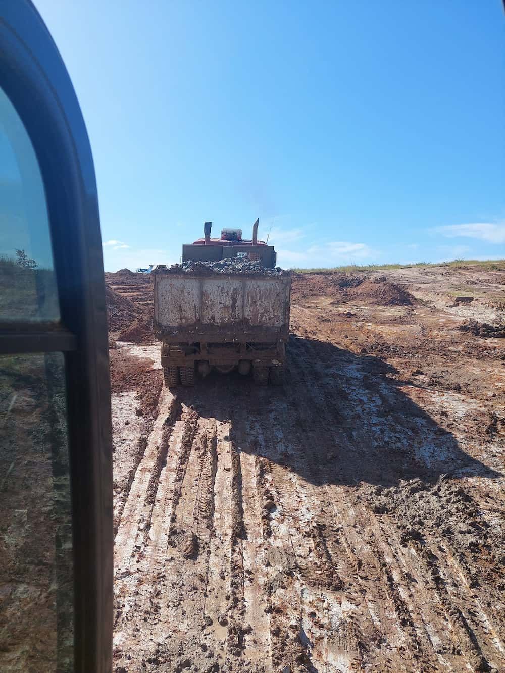 A Truck is Driving Down a Muddy Road — B E Laser Levelling QLD in Bucca, QLD