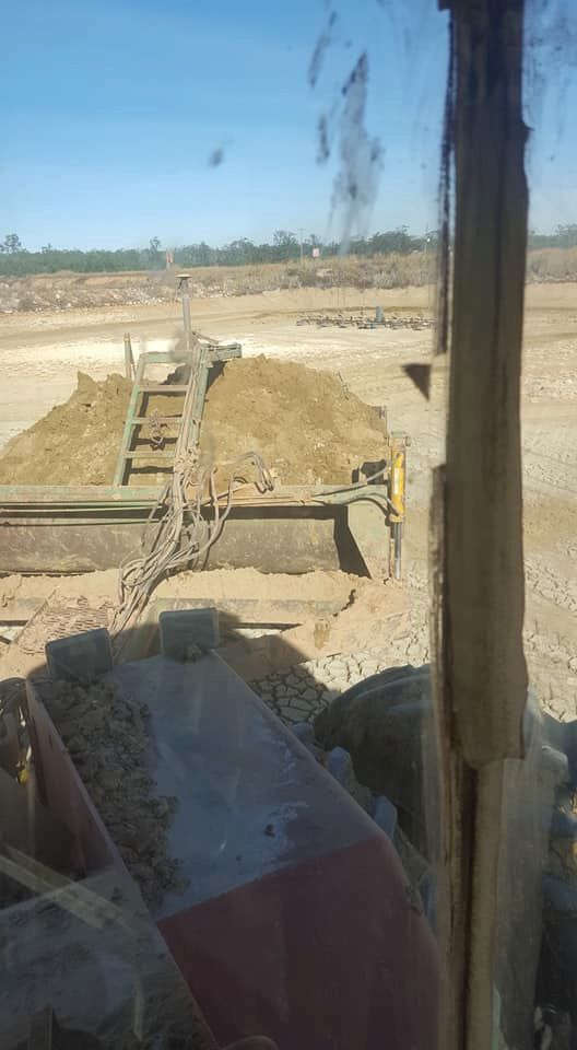A Bulldozer is Sitting in the Middle of a Dirt Field — B E Laser Levelling QLD in Rockhampton, QLD
