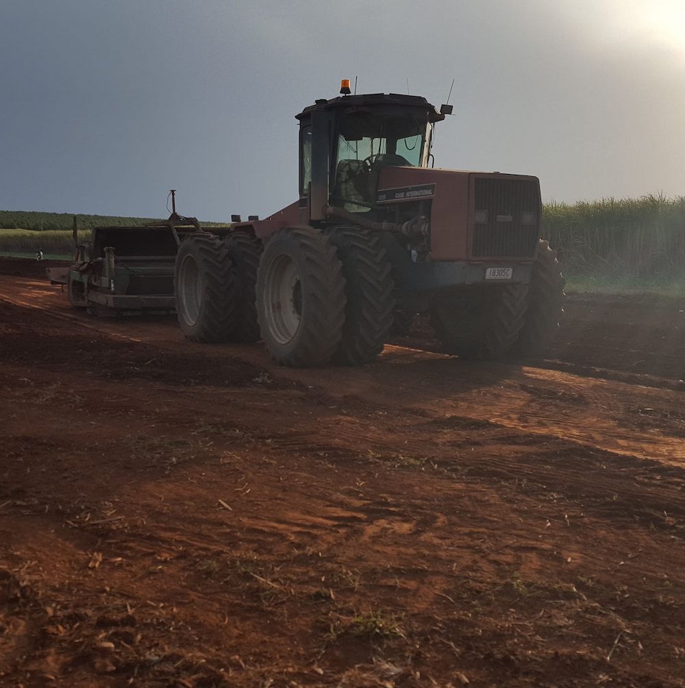 A Large Tractor is Parked in a Dirt Field — B E Laser Levelling QLD in Rockhampton, QLD