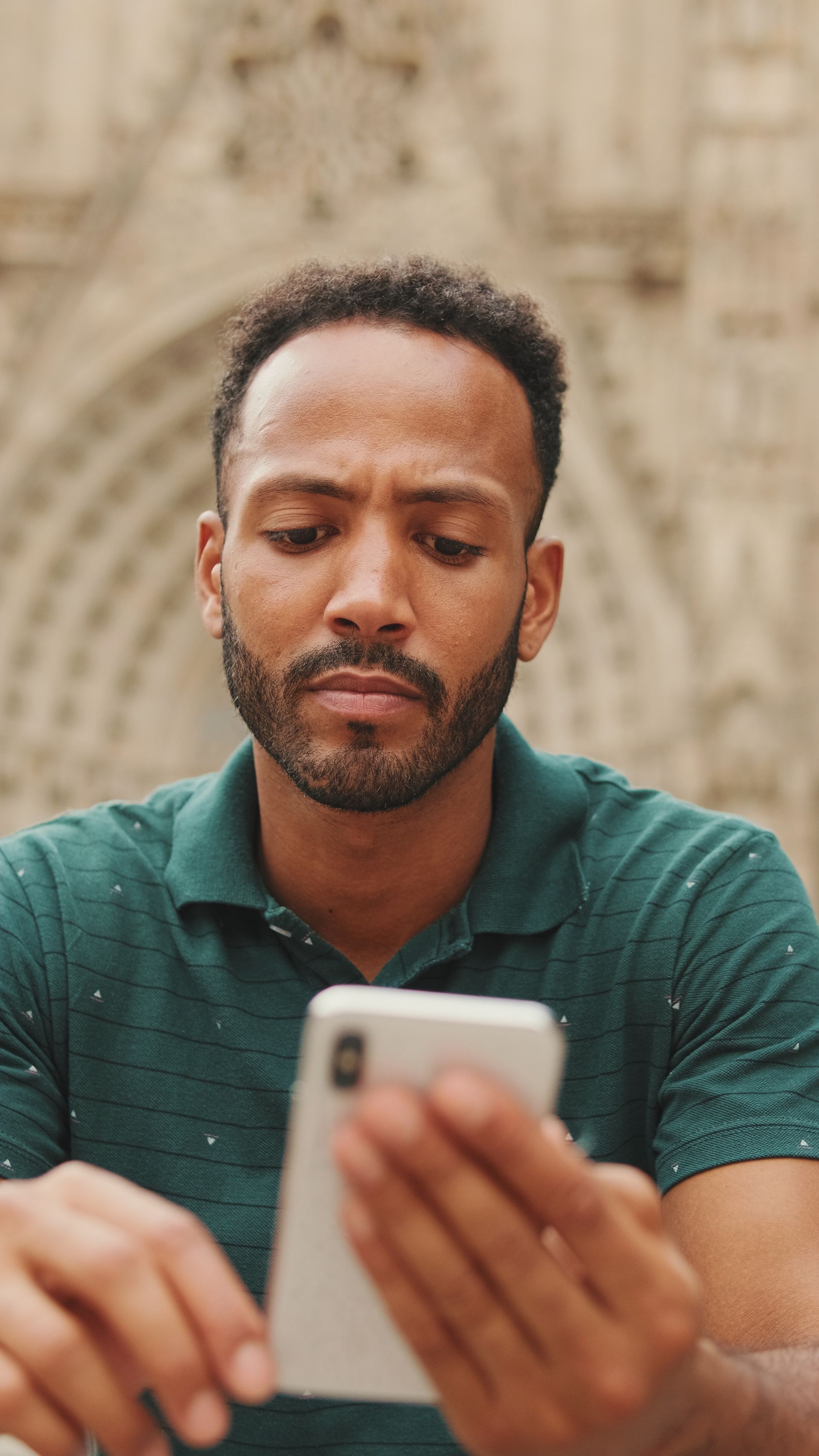 A woman wearing glasses is holding a pen to her mouth.