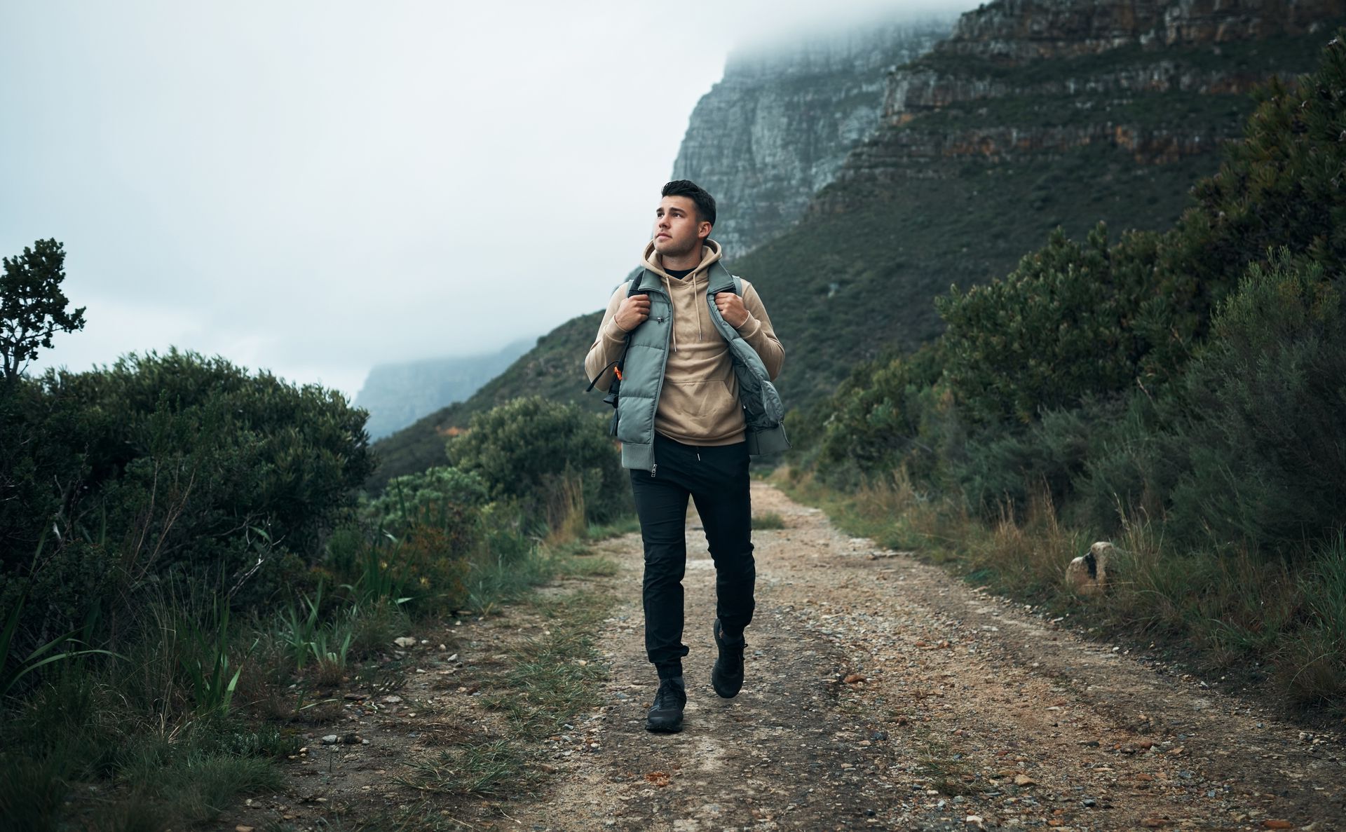 A man in a military uniform is sitting in a wheelchair holding his head.