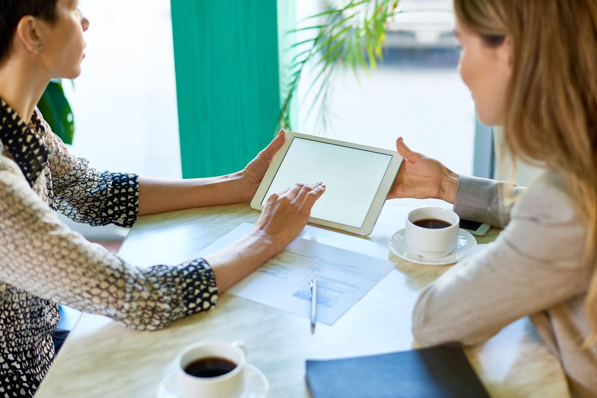A man in a military uniform is sitting in a wheelchair holding his head.