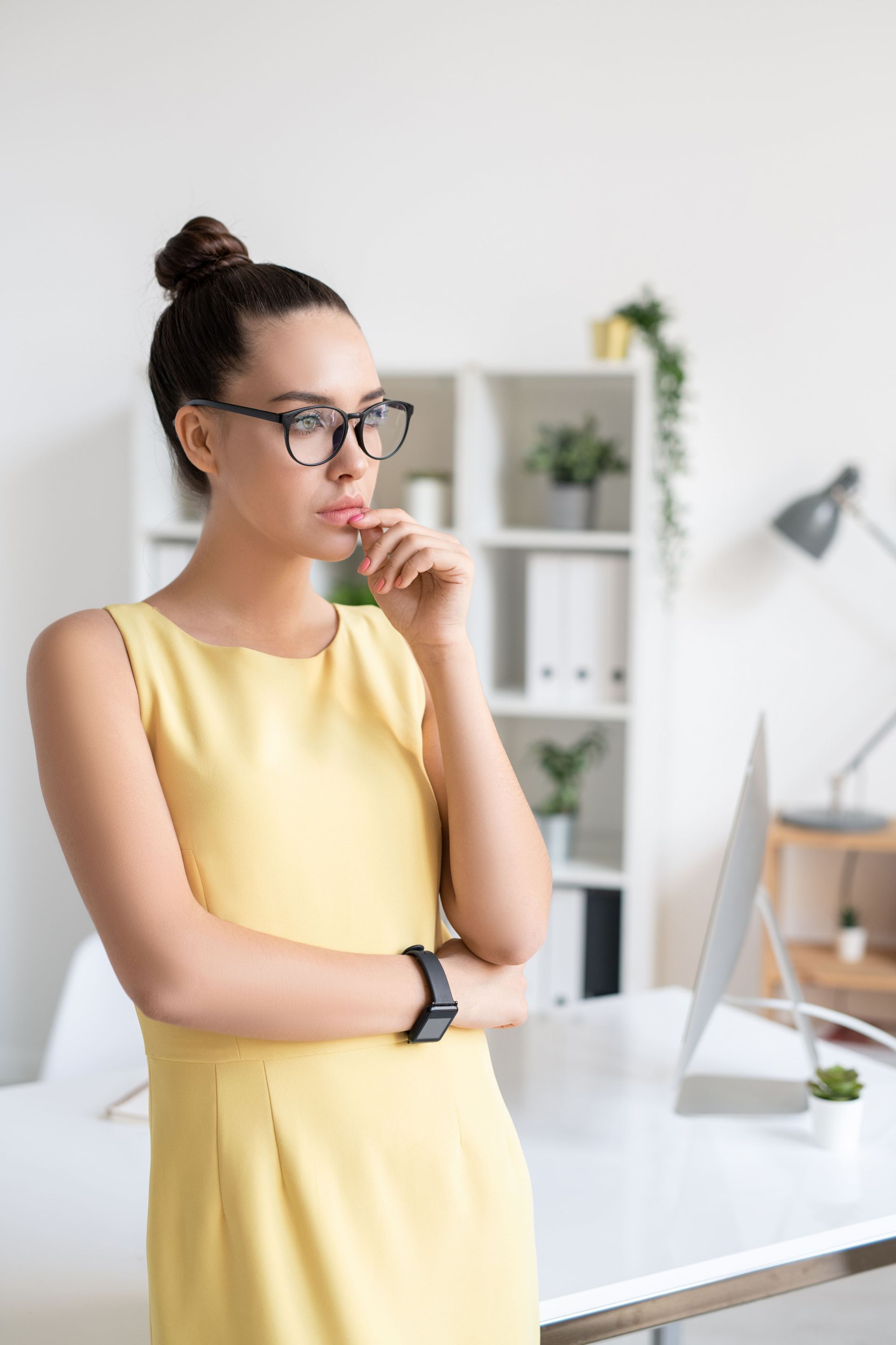 A man in a military uniform is sitting in a wheelchair holding his head.