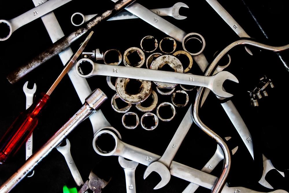 A Pile Of Wrenches And Screwdrivers On A Black Surface — Dancers Car Care In Ballina, NSW