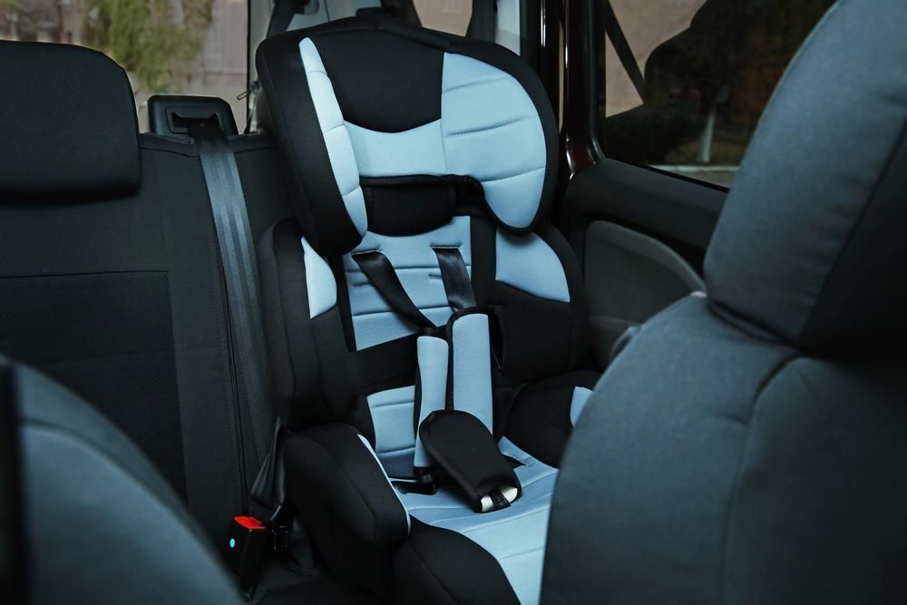 A Child's Car Seat Is In The Back Seat Of A Car — Dancers Car Care In Ballina, NSW