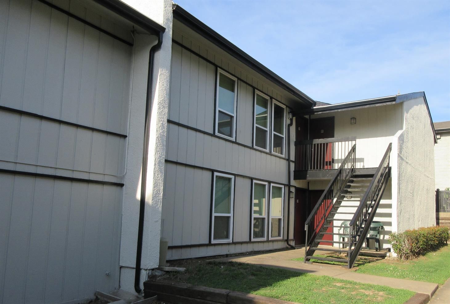 A building with stairs leading up to the second floor