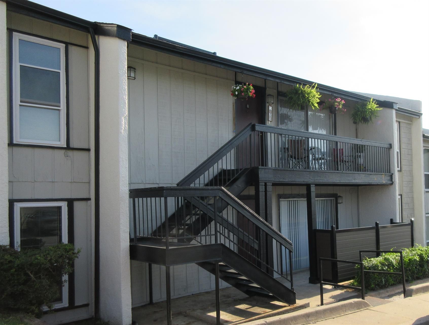 A building with stairs leading up to the second floor