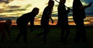 A group of people standing next to each other in a field.