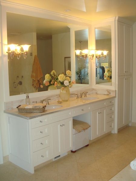 A bathroom with two sinks and a large mirror