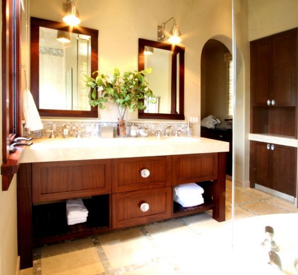 A bathroom with a double sink and two mirrors