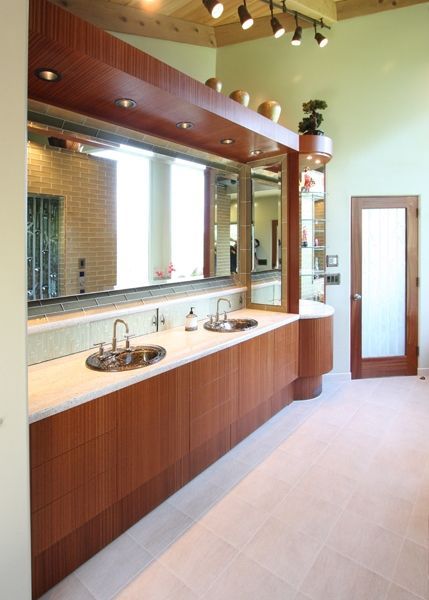 A bathroom with two sinks and a large mirror