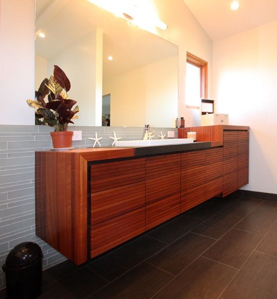 A bathroom with two sinks and a large mirror