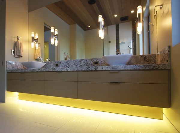 A bathroom with two sinks and a large mirror