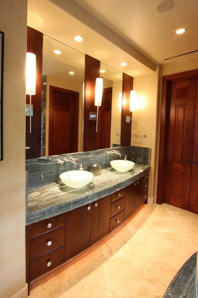 A bathroom with two sinks and a large mirror