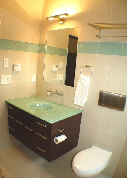 A bathroom with a toilet a sink and a mirror