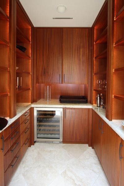 A kitchen with wooden cabinets and a wine cooler