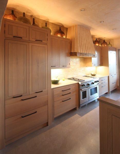 A kitchen with stainless steel appliances and wooden cabinets