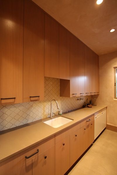 A kitchen with wooden cabinets and a sink