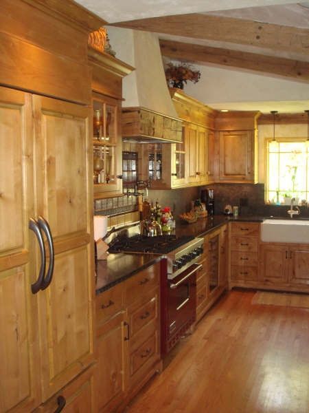 A kitchen with wooden cabinets and a sink
