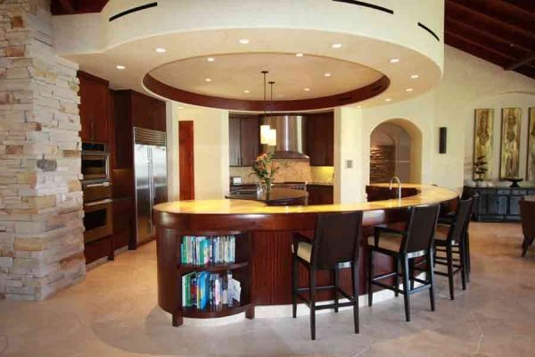 A kitchen with a large island and stools