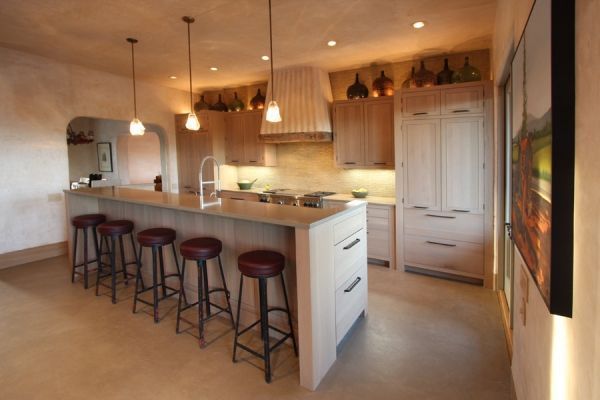 A kitchen with a large island and stools