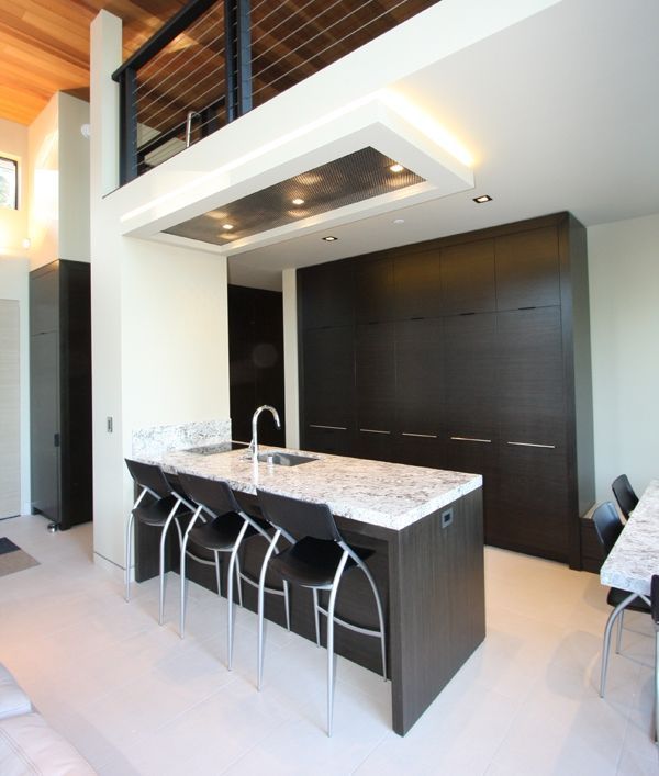 A kitchen with a large island and a sink