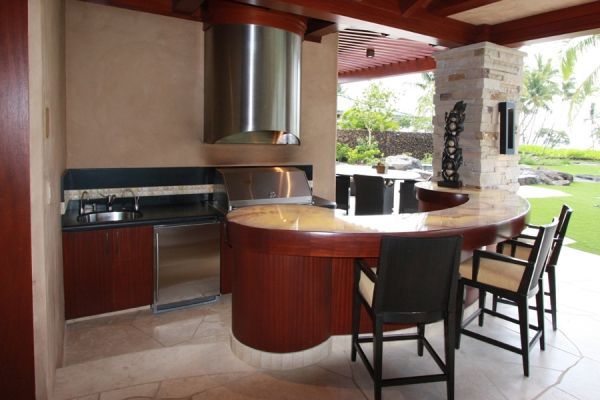 A kitchen with a bar and chairs in it