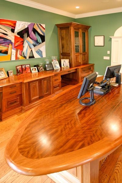 A wooden desk with two computer monitors on it