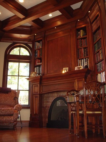 A living room with a fireplace and bookshelves