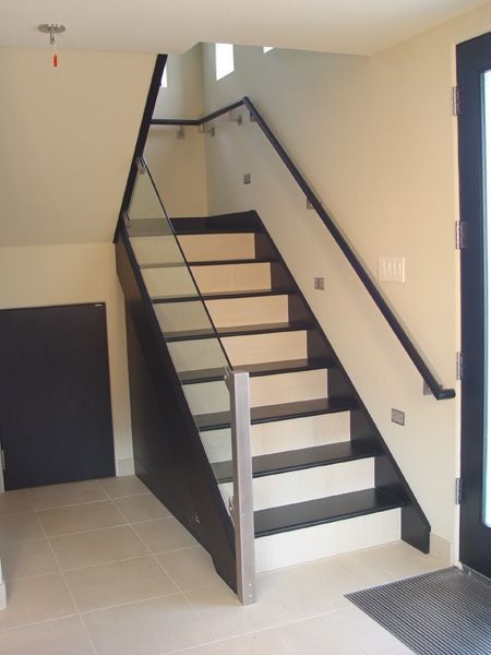 A black and white staircase with a glass railing