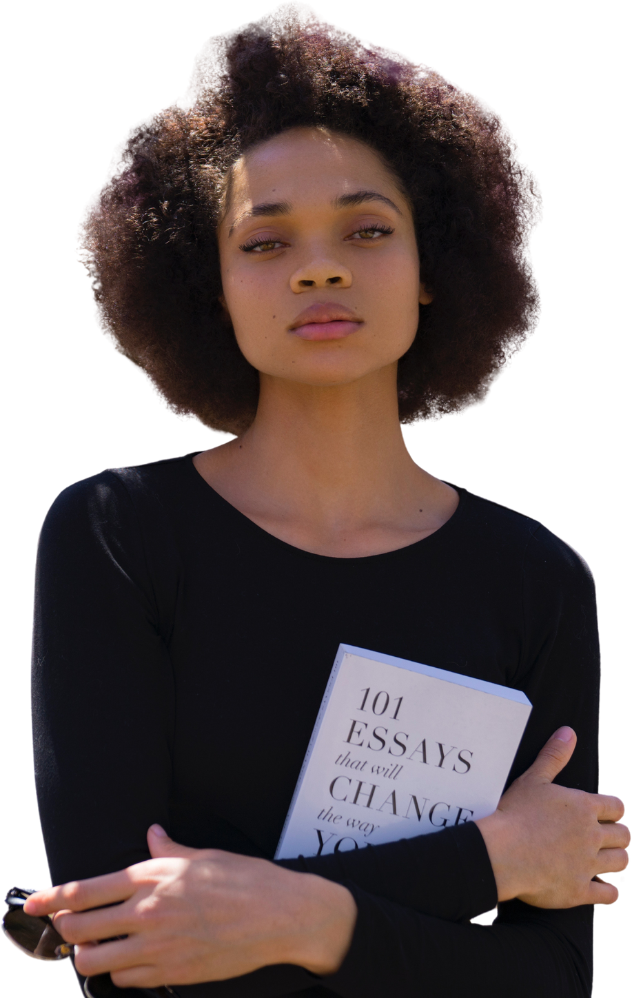 A woman with an afro is holding a book in her hands