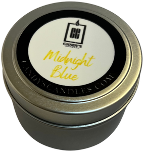 A candle in a tin that says midnight blue