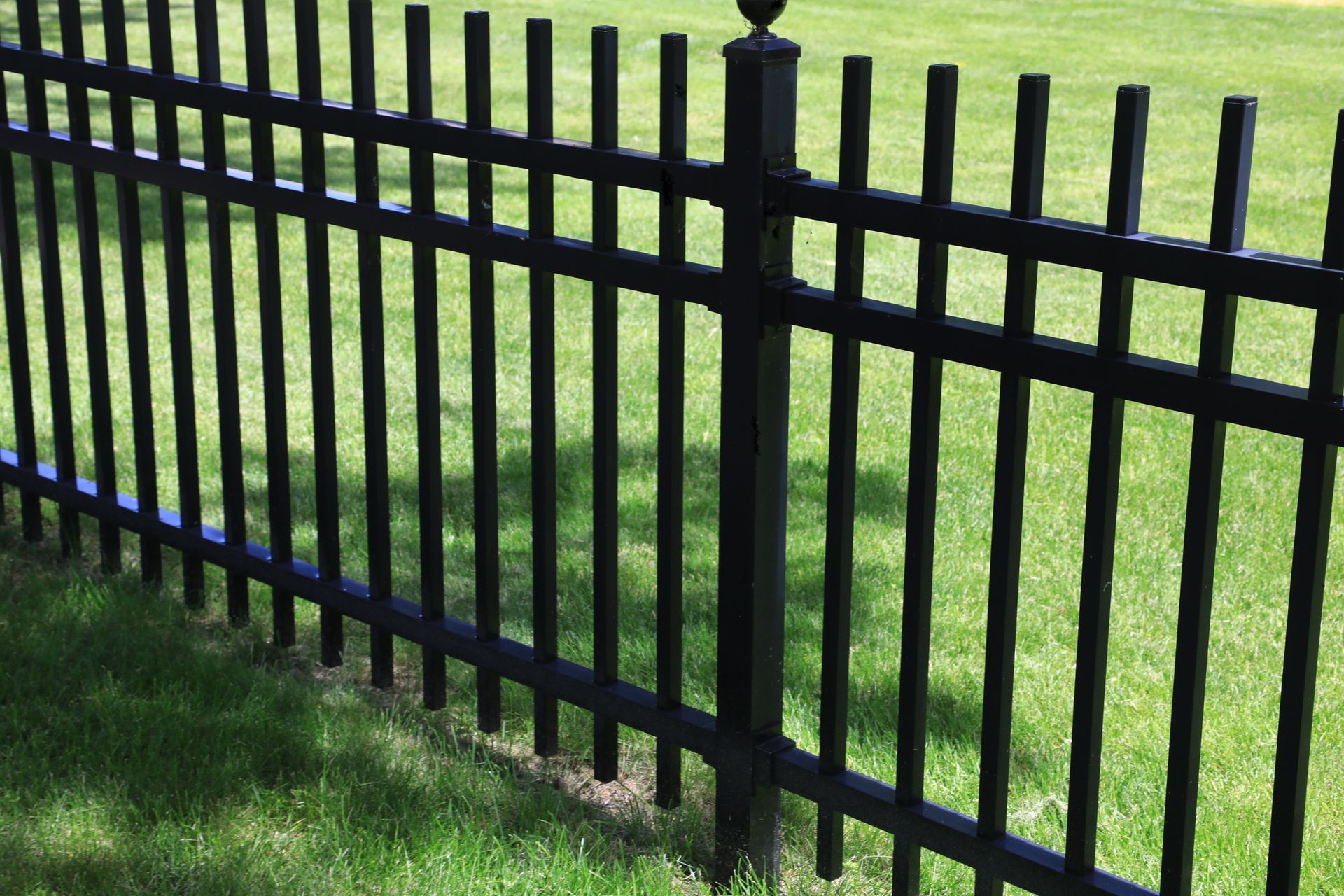 Stylish black iron fence for lasting security and elegance.