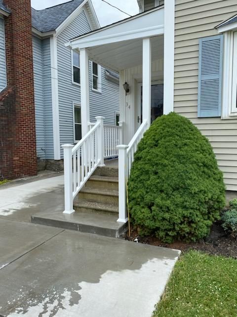 A house with a porch and stairs leading up to it