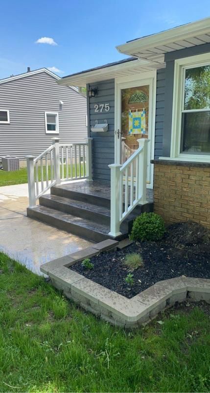 The front of a house with stairs and a porch.