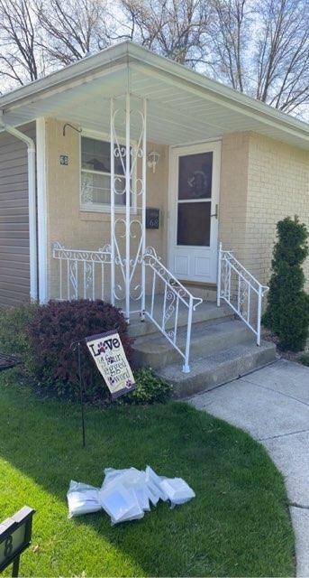 A house with a porch and stairs is for sale.