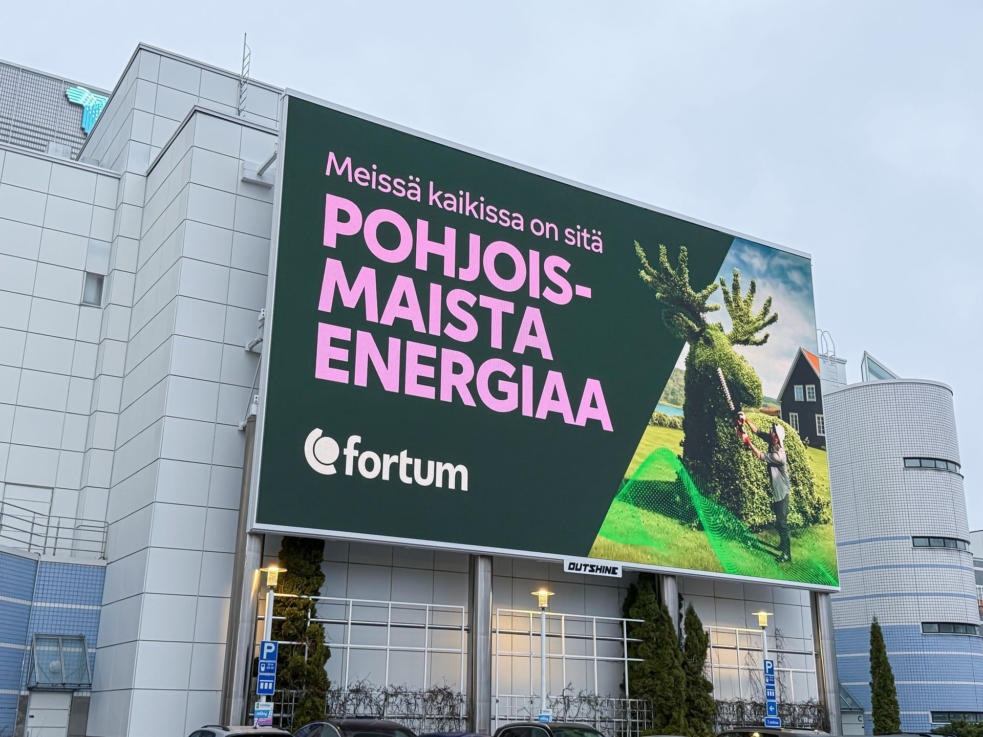 Suuri mainostaulu rakennuksessa, jossa mainostetaan Fortum energiaa suomeksi. Kuvassa on hirvi ja teksti ”Pohjoismaista Energiaa”.