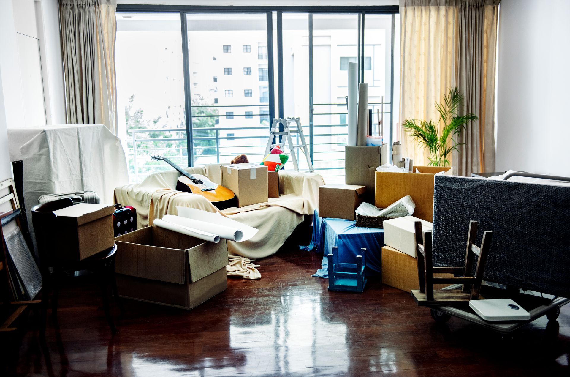 A living room filled with boxes and a couch.