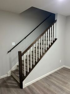 A staircase with a wooden railing in a room.