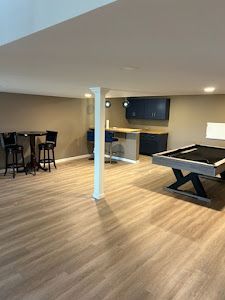 There is a pool table in the middle of the room.