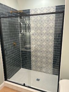 A bathroom with a walk in shower and a toilet.