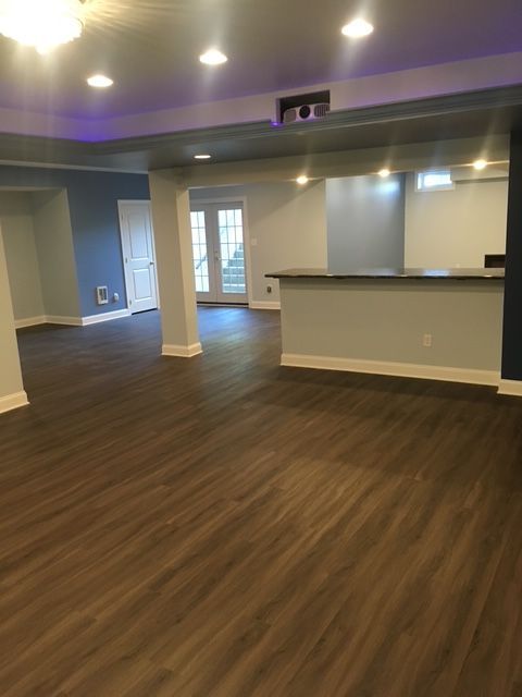 A large empty room with hardwood floors and a counter