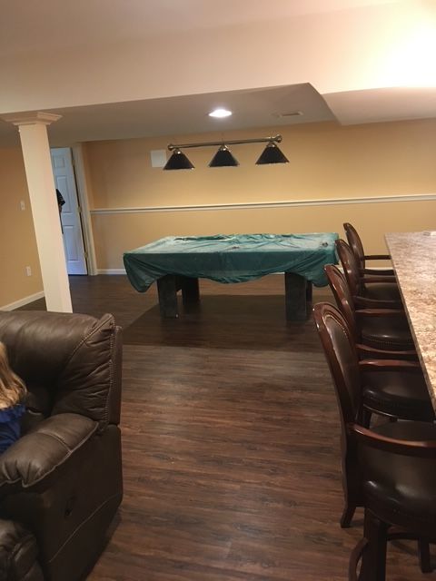 There is a pool table in the middle of the room.