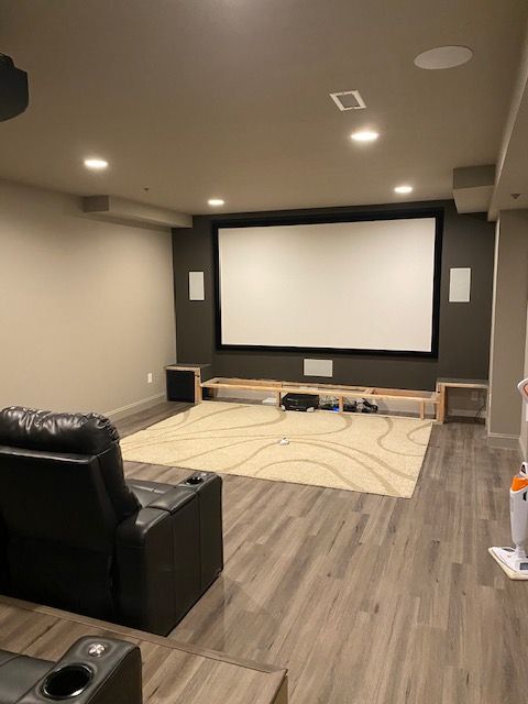 A home theater with a large screen and a couch.
