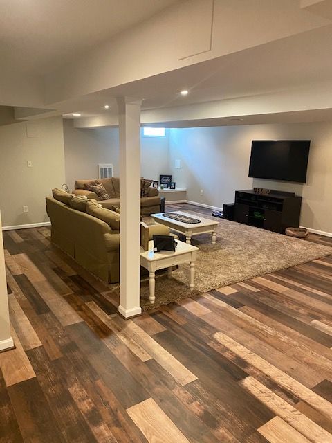 A living room with a couch , table , and television.