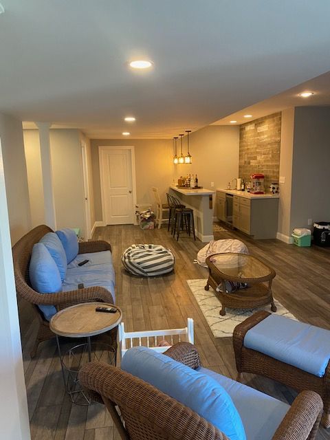 A living room with a couch , chairs , and a table.