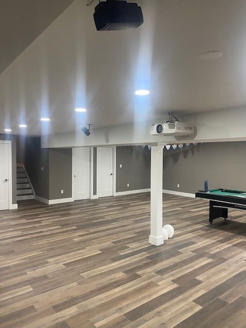 There is a pool table in the middle of the room.